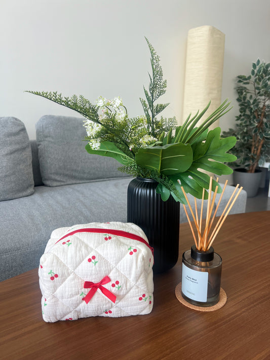 Beauty pouch with cherry designs. Perfect for makeup, skincare and more.