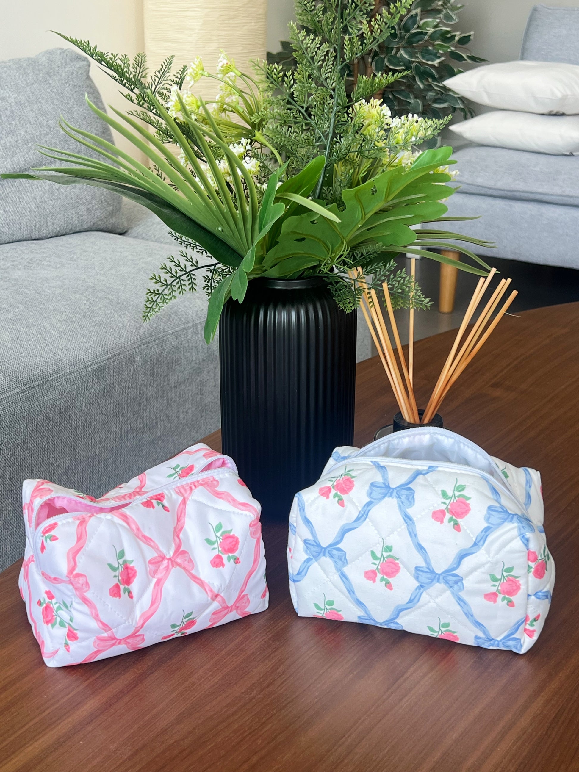 Blue and pink beauty pouches with bows and roses. Makeup bags for makeup. skincare, travel and beauty essentials.