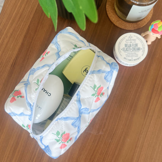 Blue makeup bag with bows and roses. Perfect beauty pouch for makeup, skincare and travel.
