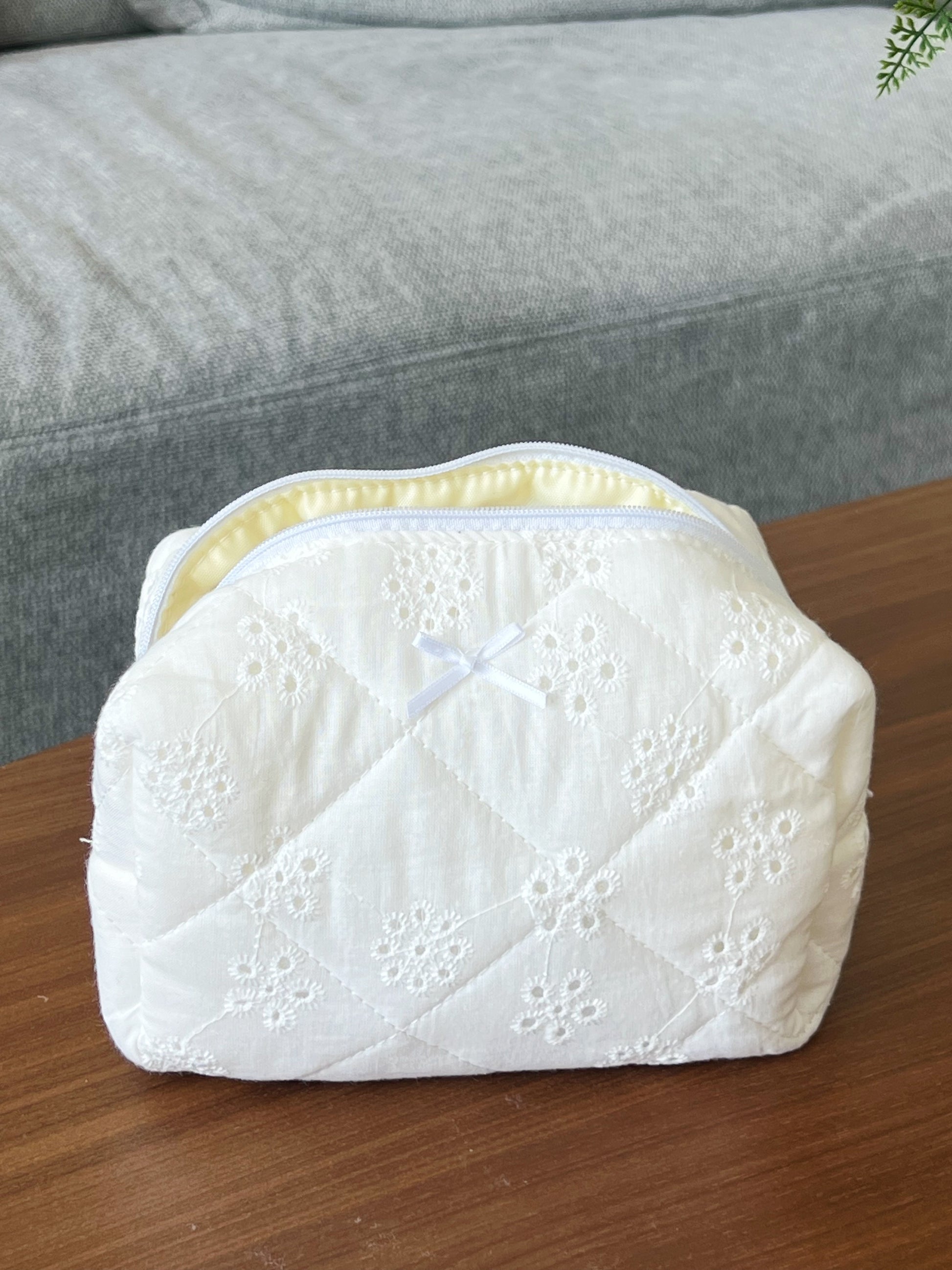 white embroidered makeup bag. aesthetic beauty pouch for skincare, makeup and beauty essentials.