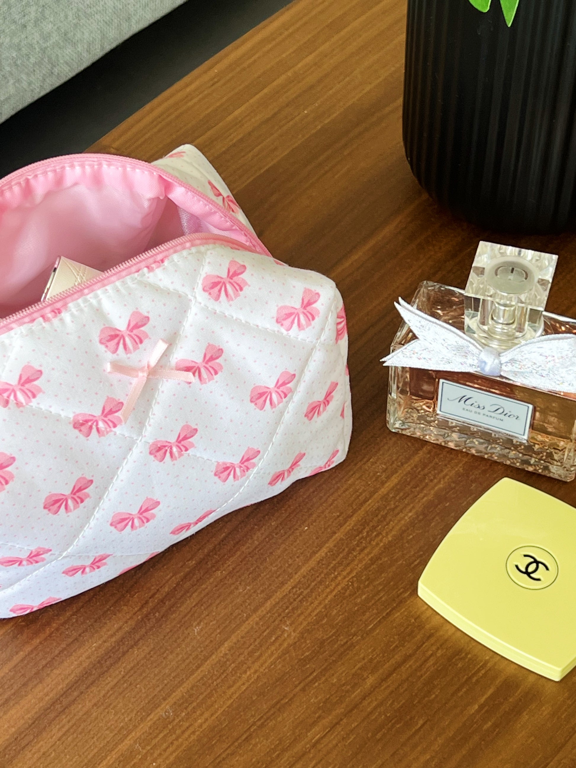 pink makeup pouch with cute little bows. Beauty pouch for makeup, skincare and travel.