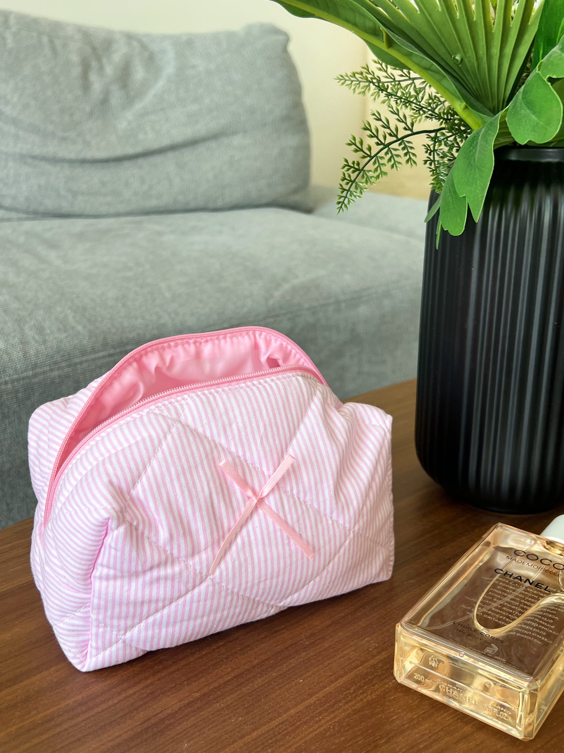 aesthetic pink beauty pouch with a bow. Perfect for skincare, makeup and beauty essentials.